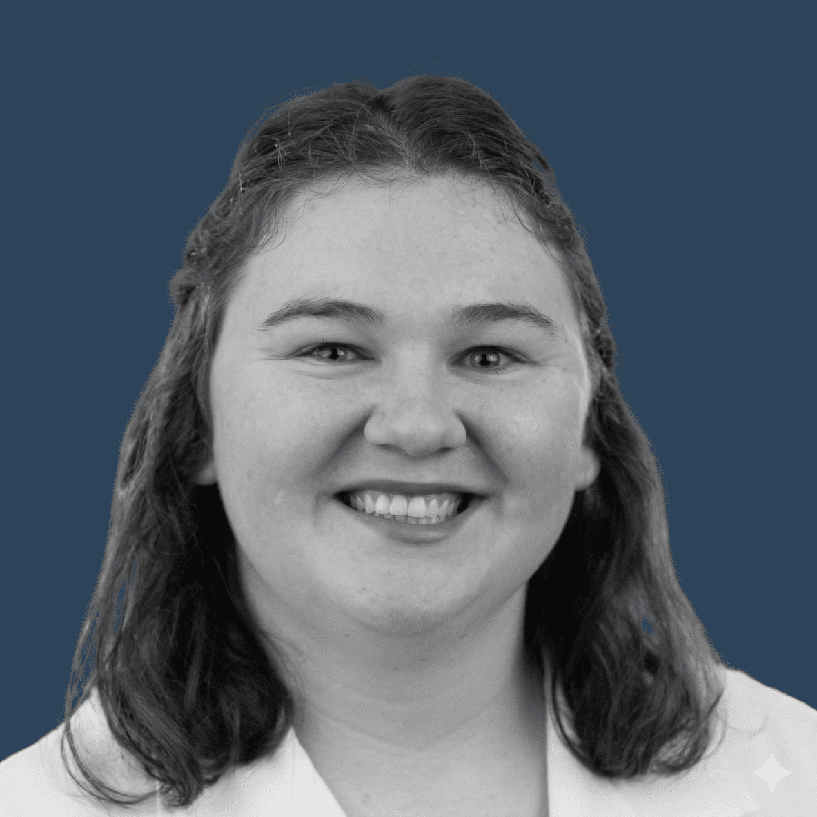 black and white headshot on dark blue background