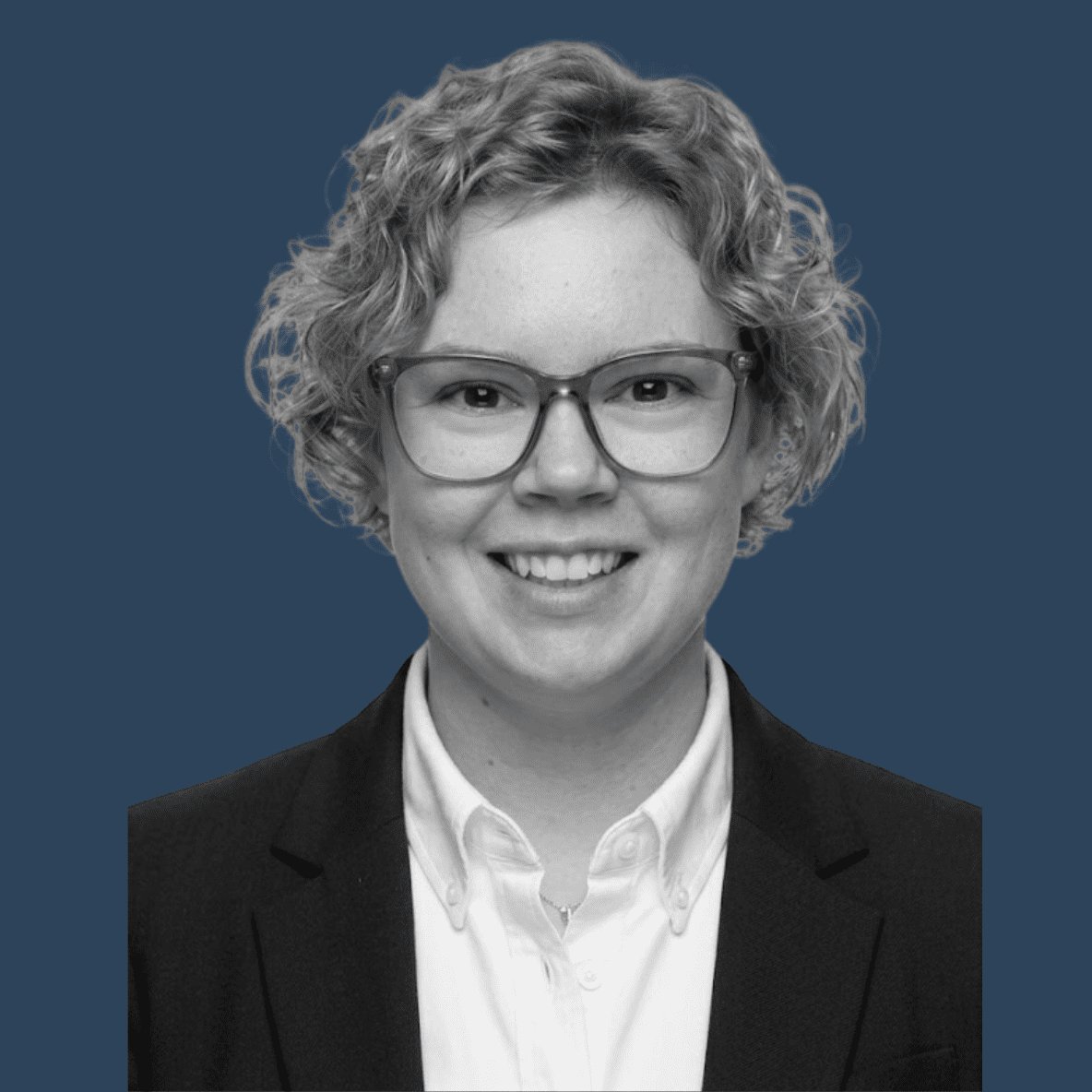 black and white headshot on dark blue background